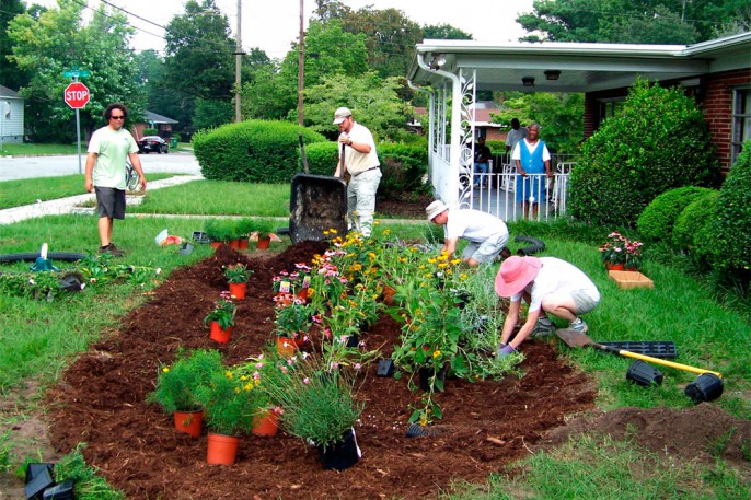 Homeowners planting a rain garden